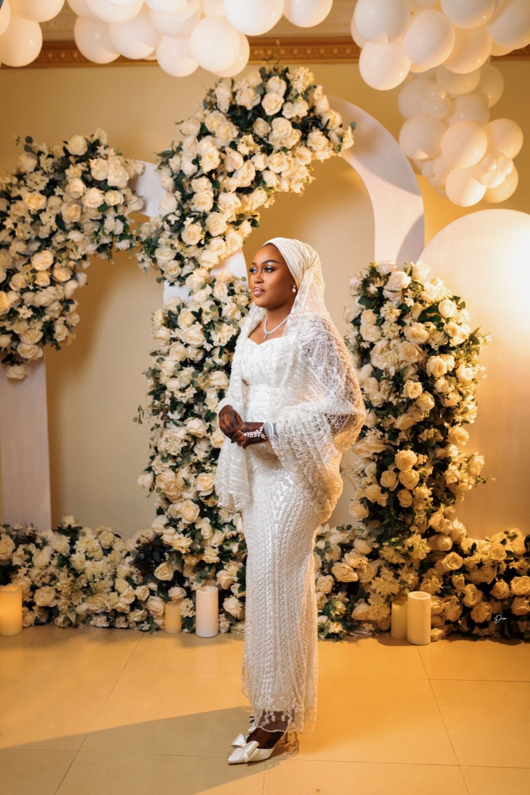 Bride styled by Haske Spa and Events, full-length in front of a floral arch