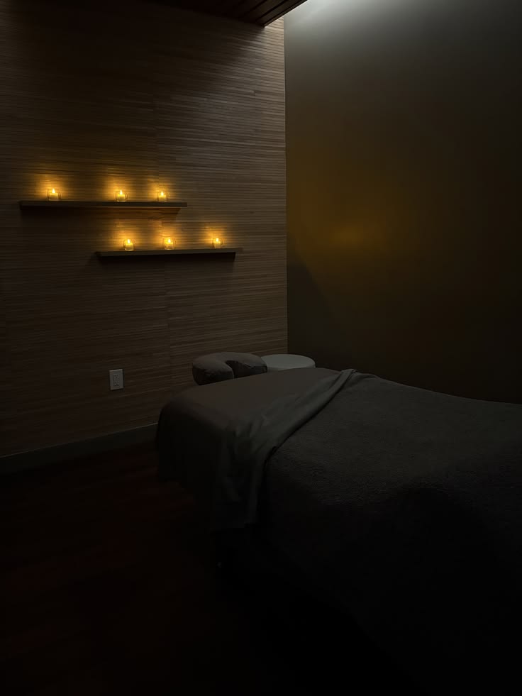 Candlelit spa relaxation room with massage table by Haske Spa and Events