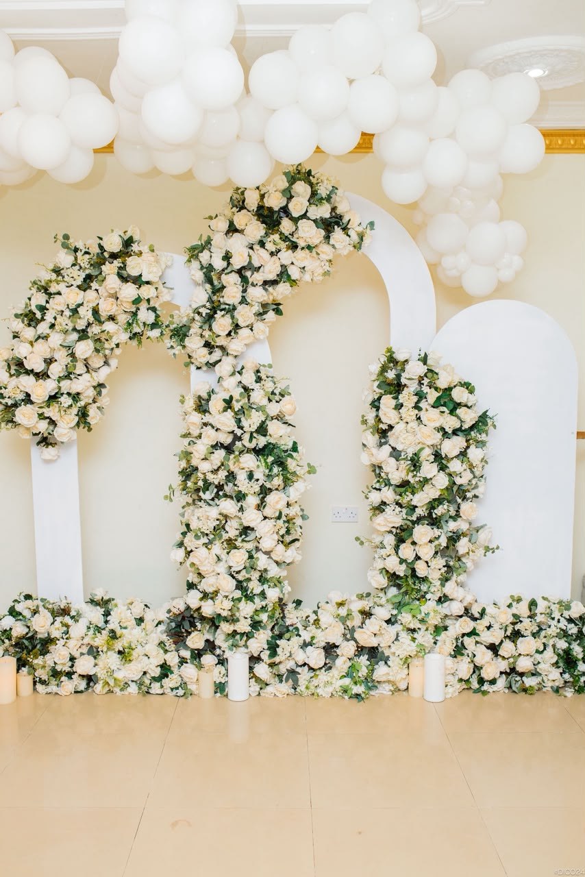 White floral and balloon backdrop setup by Haske Spa and Events